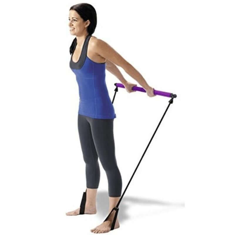 A woman using a Pilates stick squat training bar with bands for a home workout, enhancing fitness and versatility.